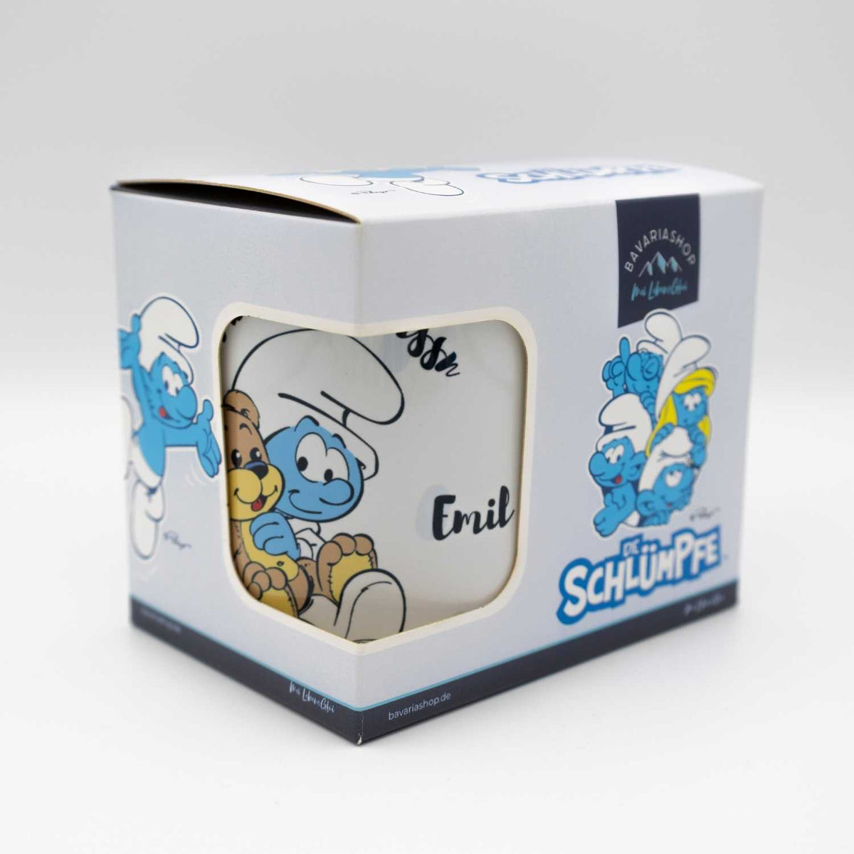 Schlümpfe Emailletasse Mei erste Tassn personalisiert, in geöffnetem Karton mit Babyschlumpf und Teddybär Motiv.