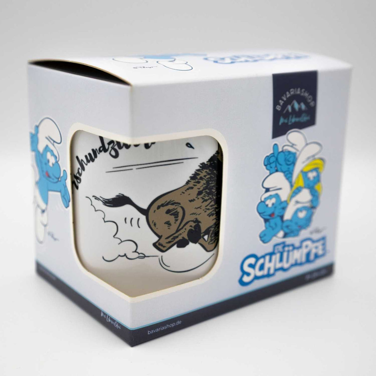 Die Schlümpfe Tasse "Himmeorschundzwirn" in offener Geschenkbox, mit Comic-Wildschwein-Motiv und Schlumpf-Druck.