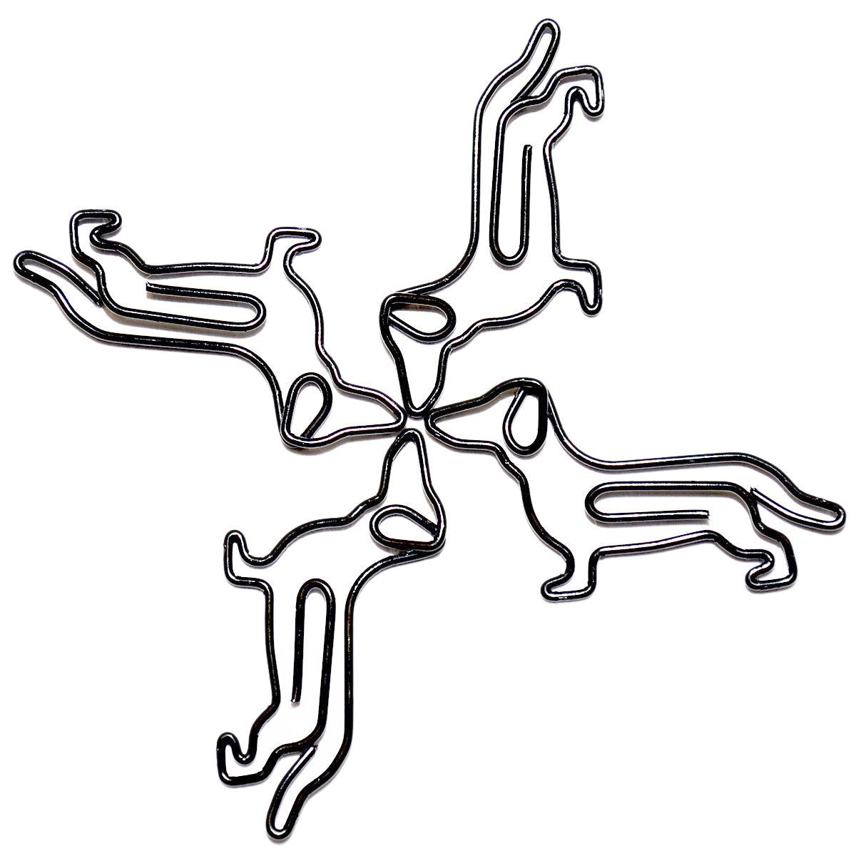 Vier schwarze Metall-Büroklammern in Form von Dackeln, spiralförmig angeordnet auf weißem Hintergrund.
