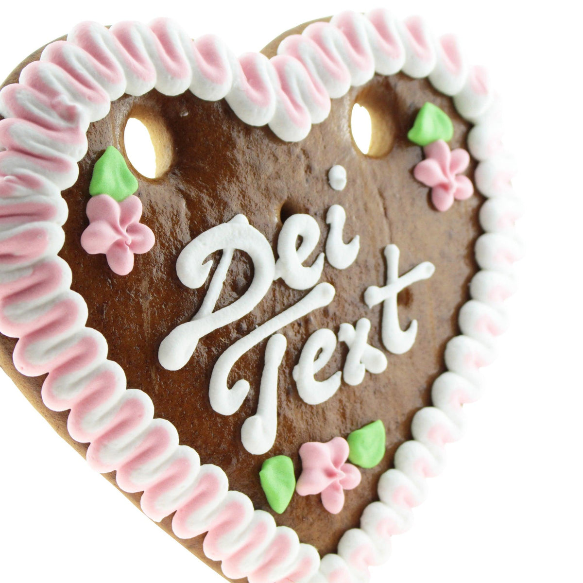 Braunes Lebkuchenherz mit weiß-rosa Zuckergussrand, grünen Blättern und rosa Blüten, Text in weißer Schrift.