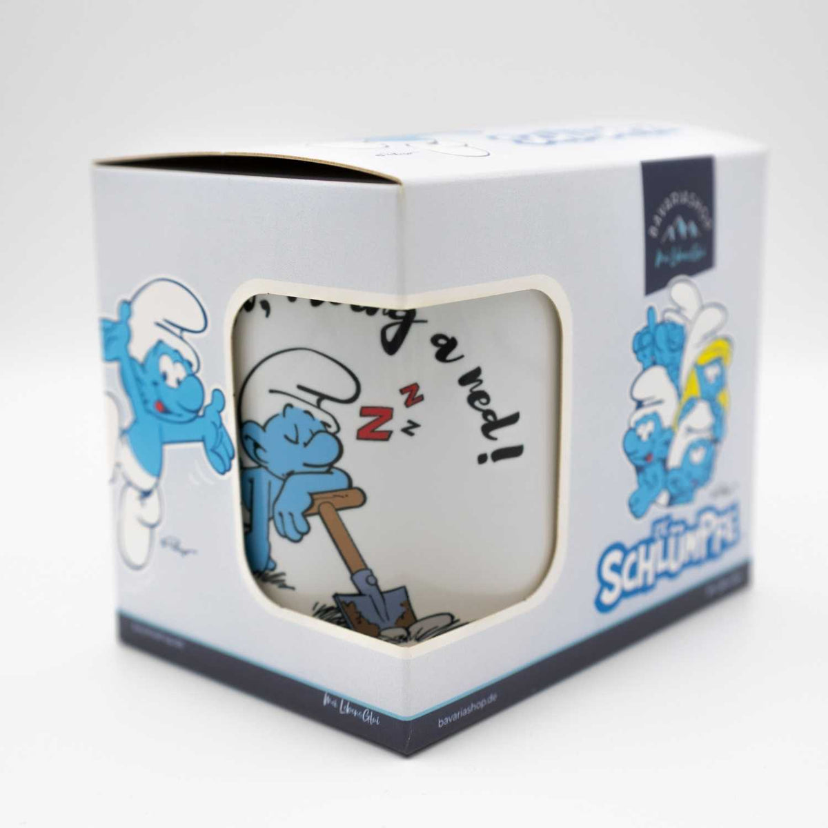 Schlümpfe Tasse Heid ned moing a ned im Geschenkkarton mit schlafendem Schlumpf und Schaufel Motiv.