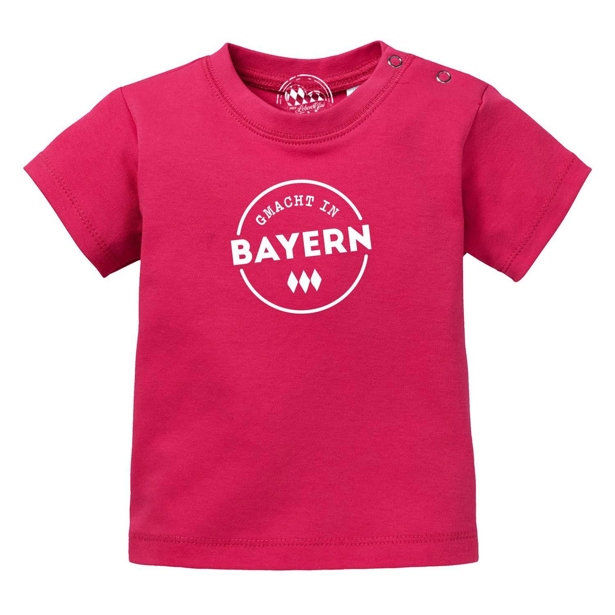 Baby T-Shirt "Gmacht in Bayern" in leuchtendem Pink mit weißem bayerischen Schriftzug mittig auf der Brust.
