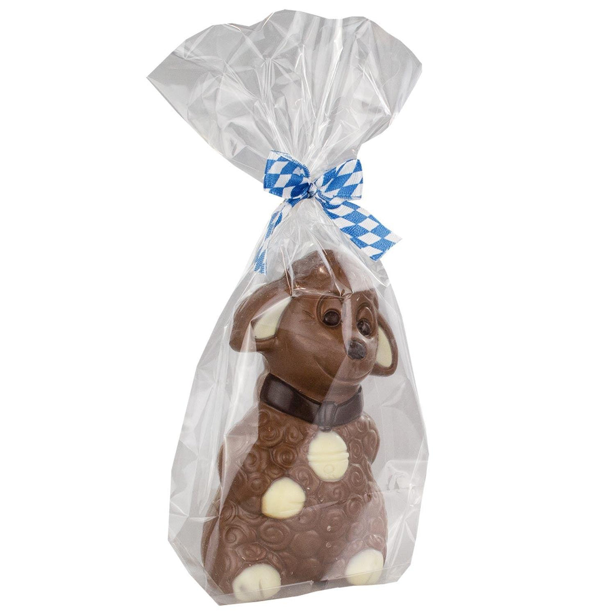 Bayerisches Schoko-Schaf in durchsichtiger Geschenkfolie mit blau-weißem Karoband, Milchschokolade mit weißen Details.