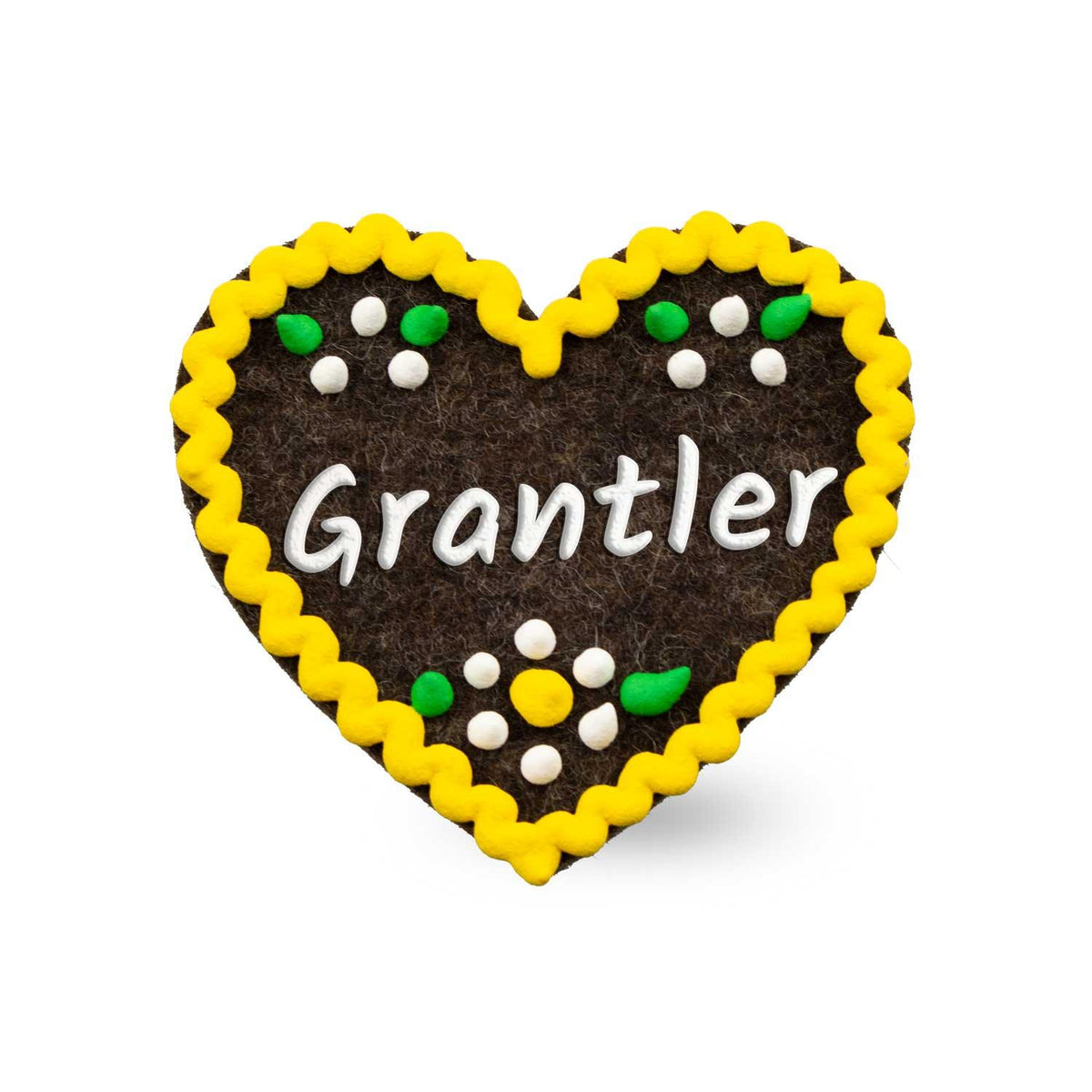 Brauner Filzherz-Anstecker "Grantler" mit gelbem Rand und bunten kleinen Blüten in Weiß und Grün.