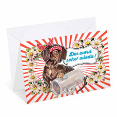Bayerische Grußkarte mit Aufschrift „Guade Besserung!“, roter Herz-Grafik und Glitzerakzenten auf weißem Karton.