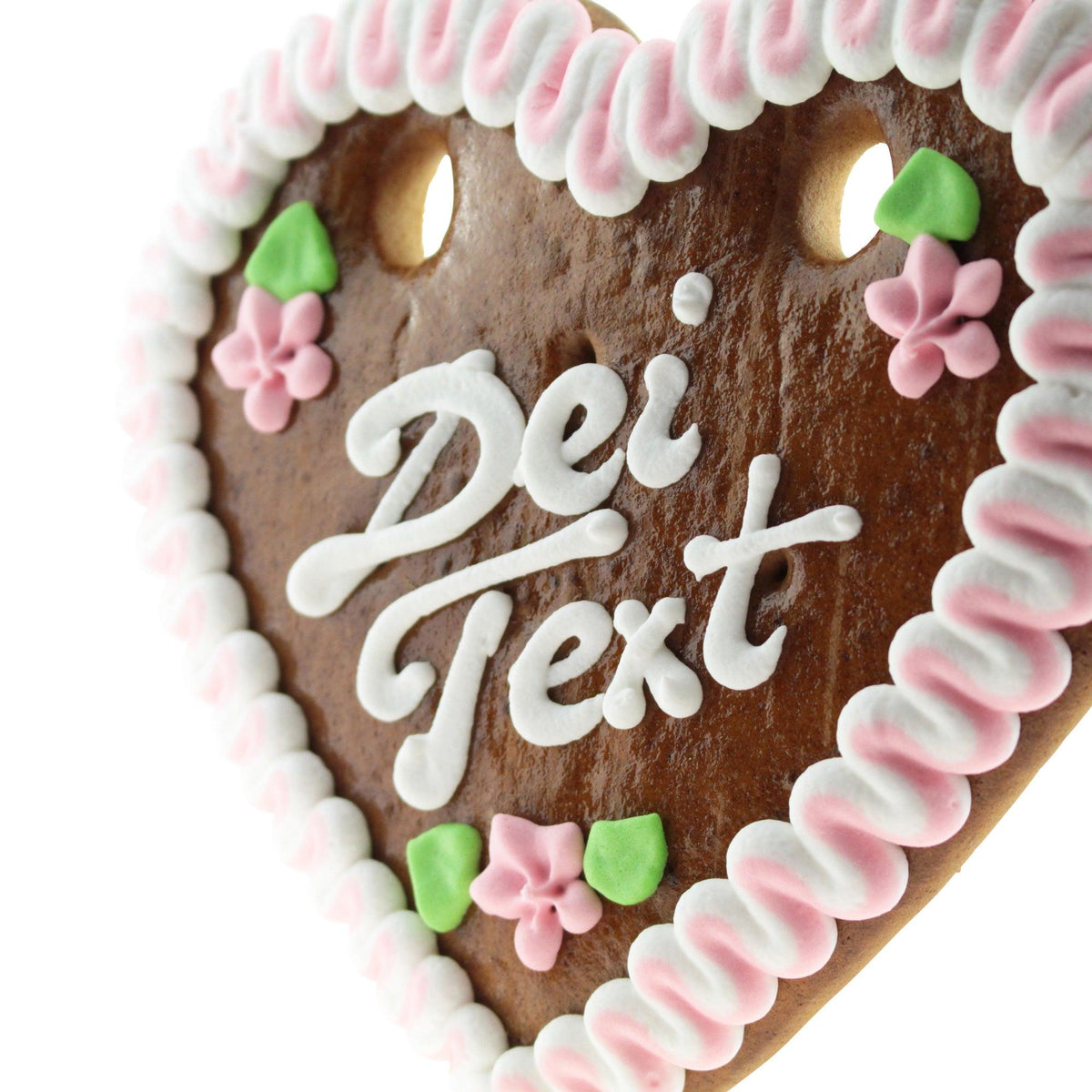 Lebkuchenherz mit weißer Zuckerguss-Aufschrift "Dei Text", rosa Blumen und grünem Blätterdekor