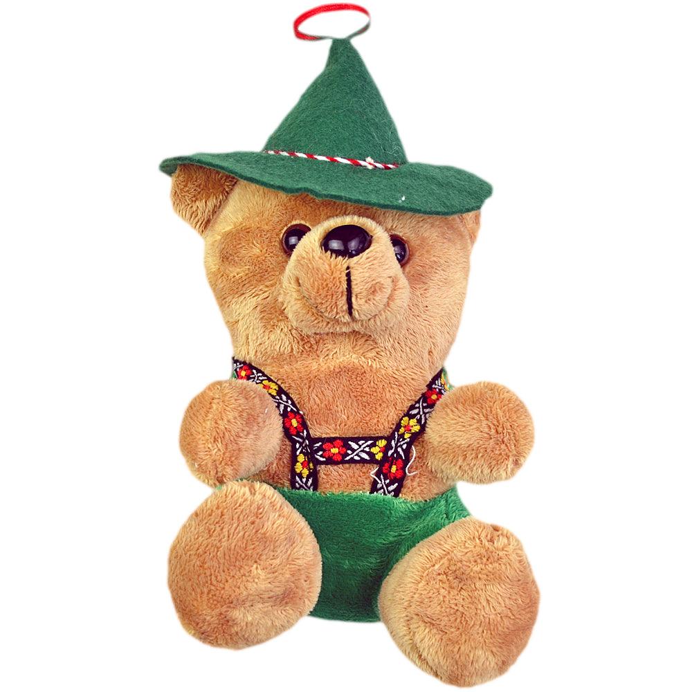 Niedlicher Plüsch-Teddybär mit grünem Filzhut, roten Bändern und traditioneller Latzhose mit Blumenmuster
