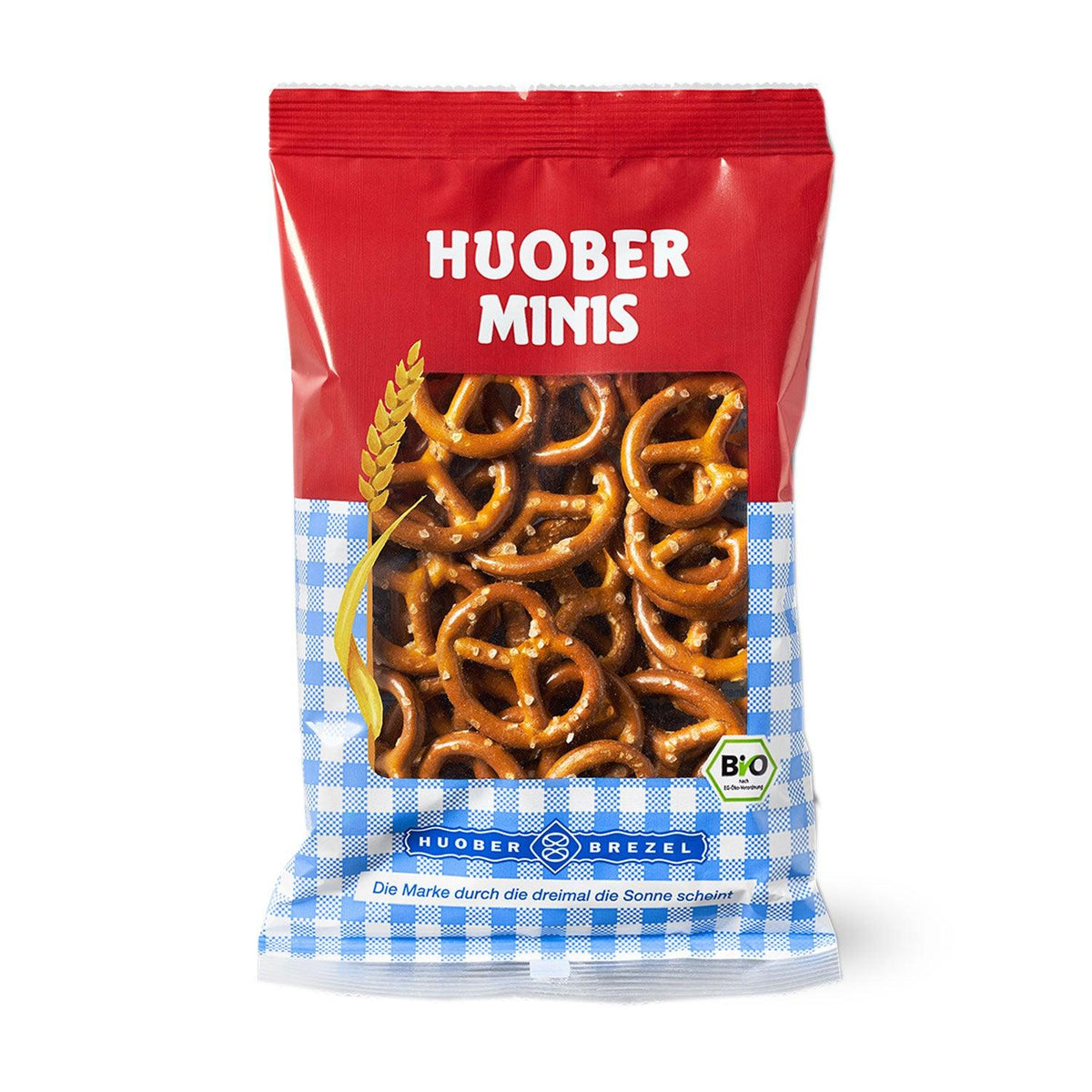 Oktoberfest-Box "Weißwurschtfrühstück" mit einer Packung Huober Minis Bio Brezeln, bayerisch kariert.